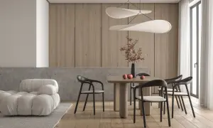 Piękne nowoczesne wnętrza: jadalnia z drewnianym stołem, czarnymi krzesłami i designerskimi lampami. Obok wygodna, biała sofa.