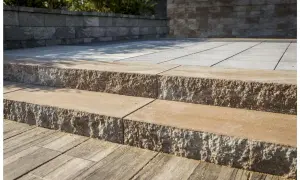 Solidne schody z bloczków betonowych prowadzą na taras. Kamienne stopnie z chropowatą fakturą.