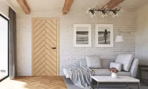 Przytulny salon w stylu modern farmhouse z drewnianą podłogą, ceglaną ścianą i dwoma obrazami z motywem morza.