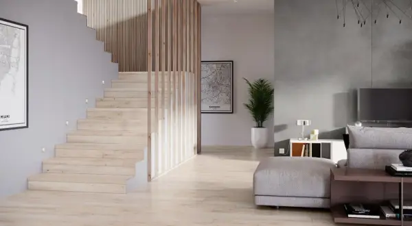 Nowoczesna klatka schodowa projekt z drewnianymi balustradami i subtelnym oświetleniem. Obok salon z szarą ścianą i wygodną sofą.