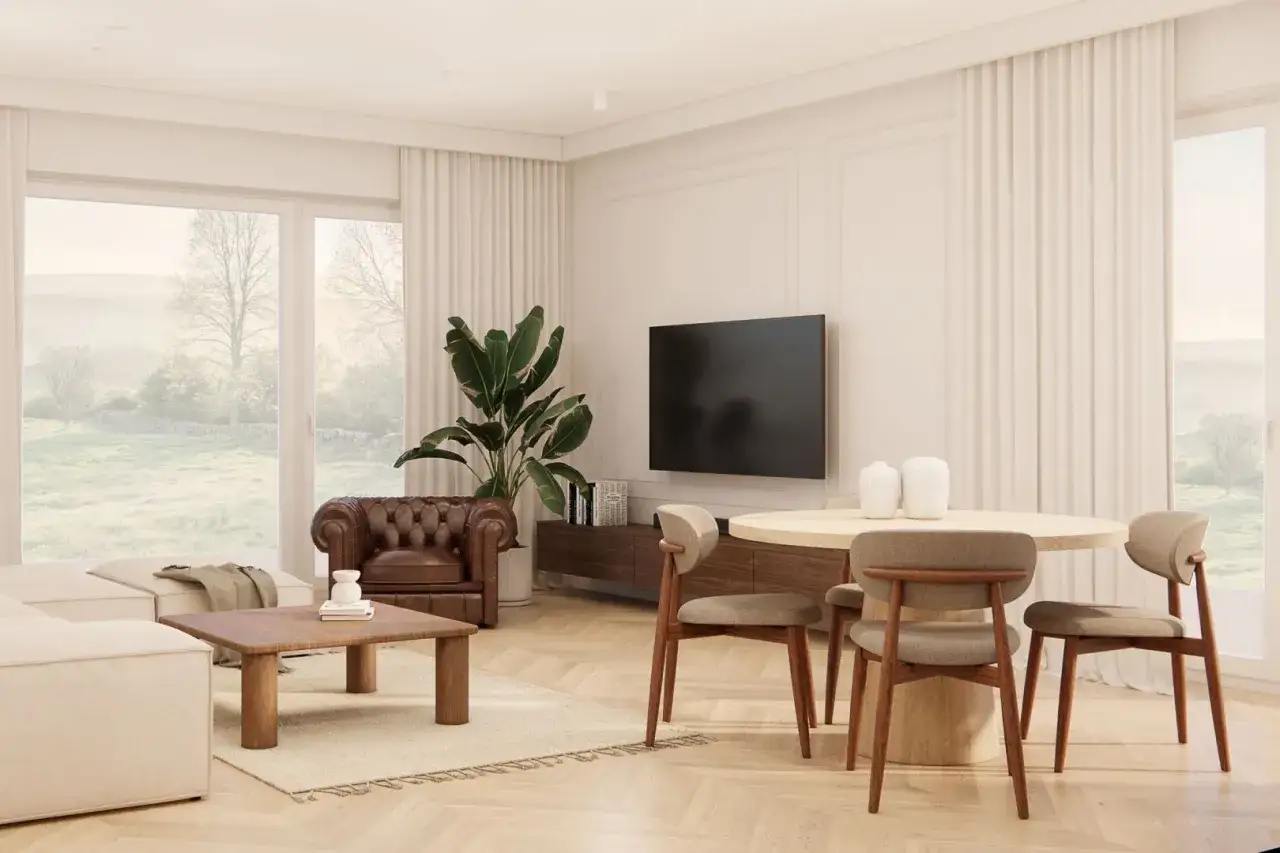 Jasny salon z wygodną sofą, skórzanym fotelem i jadalnią. Duże okna wychodzą na zielony krajobraz. To elegancki dom.